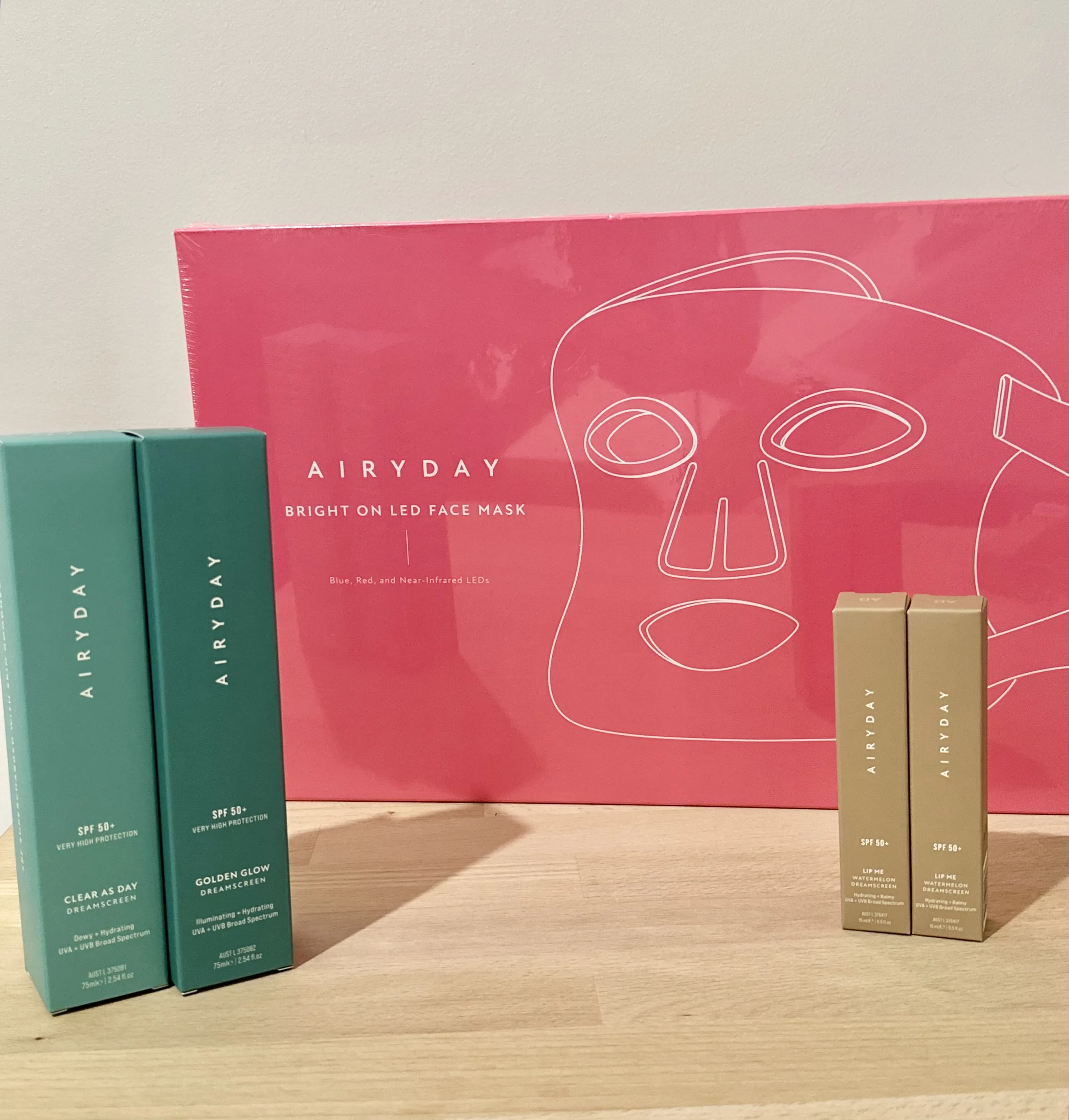 AIRYDAY SPF cartons and Bright On LED Face Mask displayed on the timber counter