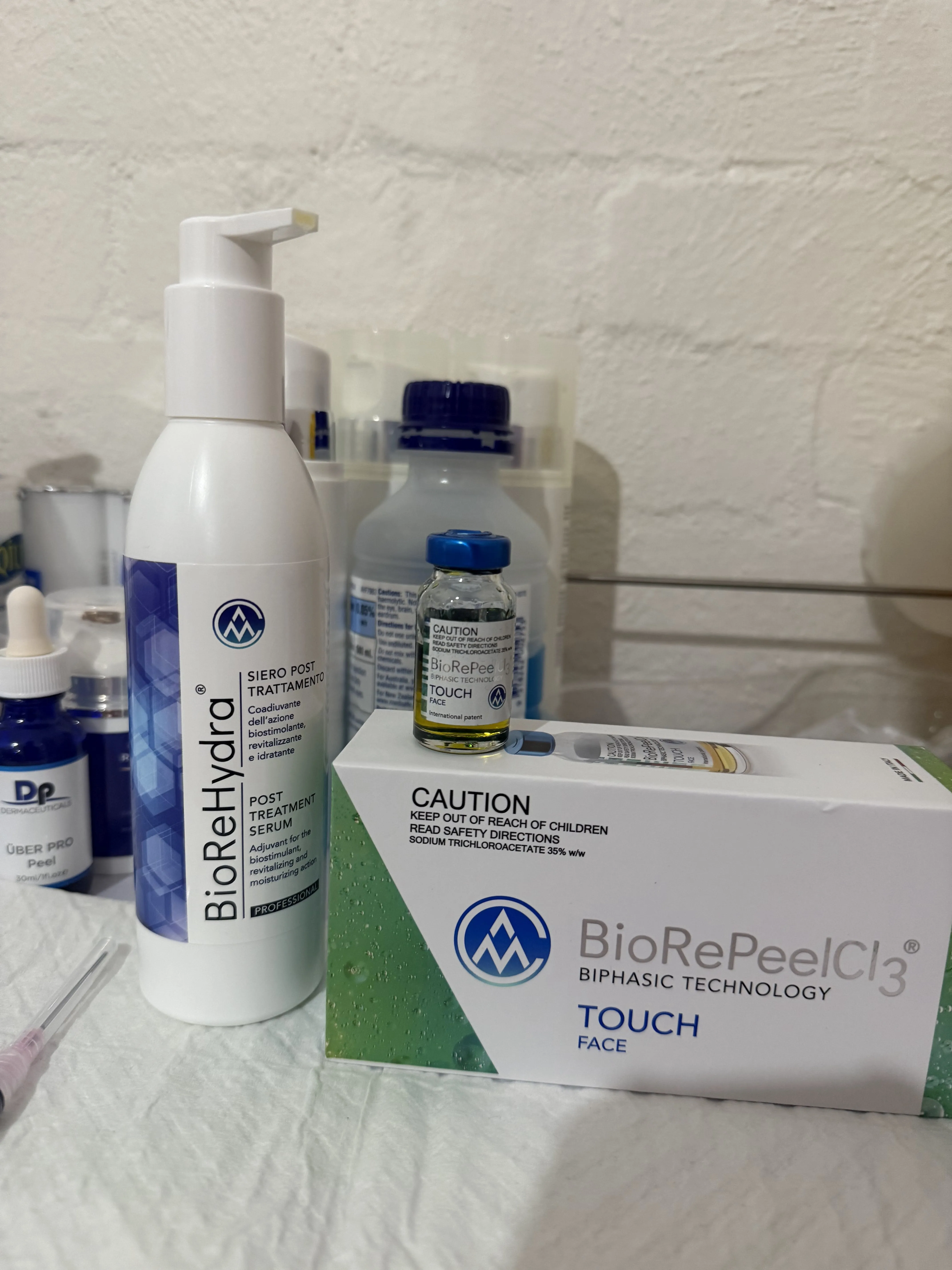 BioReHydra serum, BioRePeel CL3 vial and DP Über Pro peel arranged on treatment cloth